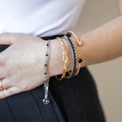 Star Double Row Bracelet, Reconstituted Onyx 7 Star Double Row Bracelet, Reconstituted Onyx -Alex And Ani Bracelets Shop gemstone hinge bangle black on model layered AA7520BO23SS 1