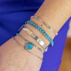 Heart Double Row Bracelet, Reconstituted Turquoise 7 Heart Double Row Bracelet, Reconstituted Turquoise -Alex And Ani Bracelets Shop gemstone hinge bangle blue on model layered AA7520TU23SS